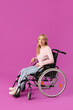 © Pixel-Shot - Mature woman in wheelchair on violet background