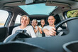 © Soloviova Liudmyla - Happy young couple with two daughters inside car during auto trop. They are smiling, laughing during road trip. Family values, traveling concepts.