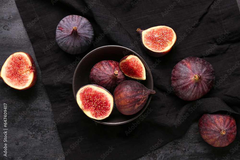 Bowl with fresh ripe figs on black background