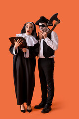 Sticker - Young couple in costumes for Halloween party with Holy Bible on red background