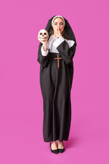 Sticker - Young woman dressed for Halloween as nun with skull showing silence gesture on color background