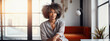 © Elena - Lifestyle portrait of mature black woman sitting in stylish modern interior industrial loft living space