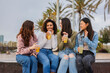 © PintoArt - Diverse young multiracial women holding cocktail glasses outdoors - Happy group of friends having fun together on summer vacation - Vacation concept -