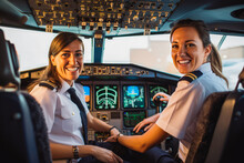Beautiful smiley woman pilot and her co pilot in cockpit ready for take off, woman on high work position