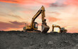 Excavator on earthmoving at open pit mining. Backhoe dig ore in quarry on sunset. Heavy construction equipment and Heavy Machinery during excavation on Mine Site. Mining excavator on iron ore mining