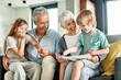 © Lumos sp - grandchild family child grandparent grandfather happy together grandmother girl senior boy read book education granddaughter grandson sofa