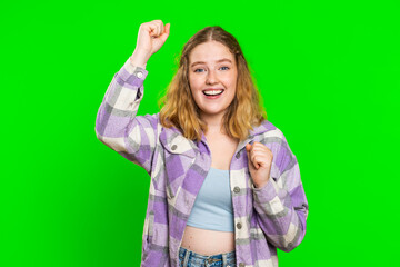 Happy joyful woman celebrating success victory, winning birthday, lottery jackpot goal achievemen, play game, good positive news, triumph. Young redhead girl isolated on green chroma key background