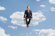 © Ljupco Smokovski - Professional man in suit and tie sitting on a cloud