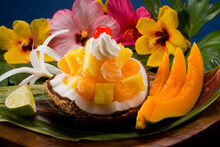 Studio Shot Of A Tropical Fruit Salad With Flowers.