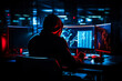 © MVProductions - Cyber security specialist using computer, preventing hacker attack, online protection, digital security expert, firewall, hacker. Dark background with bright colorful monitors