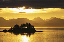 A Summer Sunset Colours The Sky Adjacent To Lynn Canal, With Chilkat Mountains In The Distance; Alaska, United States Of America