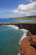 Shark's Cove With Four Seasons Lanai At Manele Bay In Background; Lanai, Hawaii, United States Of America