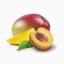 Mango And Half Of A Peach With Leaves On A White Background; Toronto, Ontario, Canada
