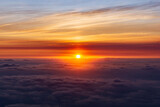 Fototapeta Nowy Jork - The beautiful view of the sun rising above the sea of ​​clouds is so exotic and full of magic