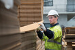 © amorn - Male warehouse worker working and inspecting quality of cardboard in corrugated carton boxes warehouse storage