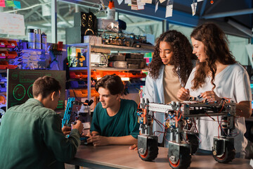 Wall Mural - Group of young people doing experiments in robotics in a laboratory