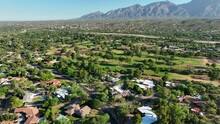 Luxury Neighborhood In Southwest USA. Aerial Shot Reveals Golf Course And Mountains In Distance.