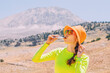 © EdNurg - Pretty young woman biting on a energy sportive gel drink after a good hike in high mountains
