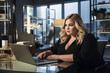© arhendrix - Plus-size managers working on modern office with laptop