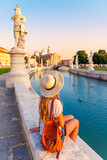 Young woman travel in Italy- Padua, Padova city, river and bridge- Prato della Valle square and Santa Giustina basilica