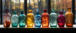 a row of six colored glass bottles sitting on top of a table