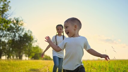 Wall Mural - happy family kids. people in the park children child running together in the park at sunset silhouette. mom dad daughter and son are run fun happy family and little child in summer. dream kids run