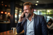 © Attasit - businessman laughing while talking on the phone