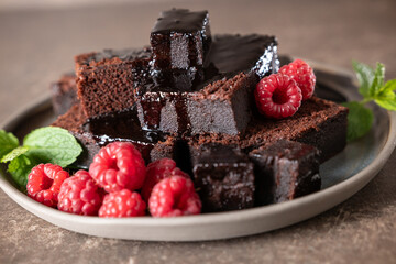 Canvas Print - Chocolate cake and fresh raspberries on a rustic plate. Brownie cake.