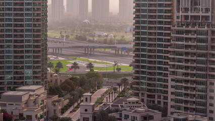 Wall Mural - Aerial sunrise view of towers in greens district area timelapse from Dubai marina.