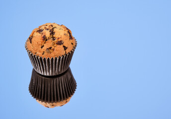 Wall Mural - Freshly baked muffin with chocolate chunky on the mirror. Copy space for text.