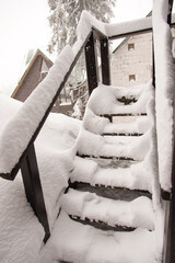 Canvas Print - Winter snow stairs. Wooden staircase of a private house. A lot of snow. Winter.