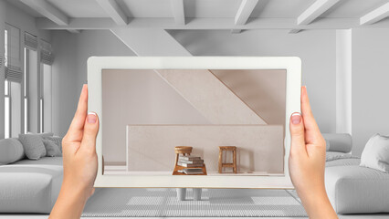 Wall Mural - augmented reality concept. hand holding tablet with ar application used to simulate furniture and de
