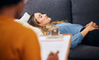 Therapy, sofa and woman relax in counselling for mental health, help for depression and listen to communication. Psychologist, consultation and patient lying on couch, writing notes and sleep comfort