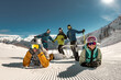 Group of happy young friends skiers and snowboarders are having fun and posing for photo at ski resort. Winter holidays concept