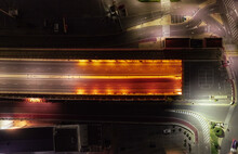 Aerial view of tunnel road at night with worm lights in Grao, Valencia, Spain.