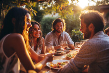 Friends Spending Time Having Lunch With Wine Outside At Sunset. Spring Summer Vacation Concept. Friendship And Fun Outdoors