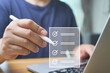 © Anucha - Business performance checklist, Quick checklist and clipboard management concept, job applicants, businessman using laptop doing online checklist survey,Employees must complete the online survey form.