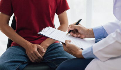 A man suffering from sexual dysfunction visits a doctor for treatment. Male health problem concept.