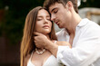 © LIGHTFIELD STUDIOS - portrait of handsome man hugging girlfriend in crop top and standing together outdoors, romance