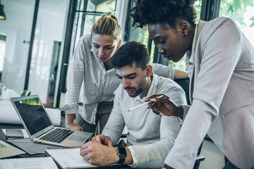 A diverse, casual design team collaborates in the office, creating innovative solutions and fostering in dynamic creative environment.	
