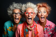 Funny portrait of three old shocked women looking at camera keeping mouth open. Sudden incredible news reaction wow.
