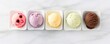 © Richa - Set of various ice cream scoops on white marble background, top view, Generative AI
