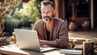 © Exuberation  - A middle-aged man studies online, eyes focused on the screen.