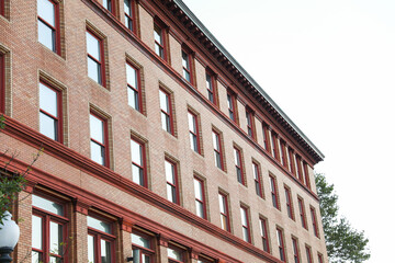 brick building with arched windows, symbolizing stability and growth in the business and mortgage industry, a hub of commerce