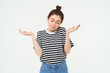 © Mix and Match Studio - I dont know. Clueless young woman shrugging shoulders, looks confused, stands against white studio background