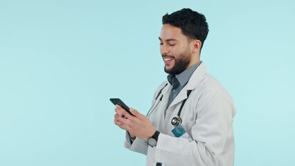 Wall Mural - Medical doctor, phone or happy man in studio for communication, social media or email. Arab healthcare worker and smartphone on blue background for telehealth consultation, network scroll or search