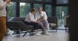 © Framestock - Adult woman sits on sofa in clinic lobby area after appointment with doctor. Doctor talks with patient about medical examination or test results. Waiting room in modern medical center. Healthcare.