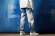 A visually striking depiction displaying a pair of bespoke denim pants, skillfully bleached and faded to create a striking ombre effect.