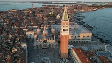 Establishing Aerial View Shot Of Venice City Skyline, St. Mark's Square With Doge's Palace, Basilica, And Campanile, Italy