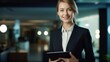 © WS Studio 1985 - Smiling businesswoman using tablets pc and standing looking at camera in office. generative ai